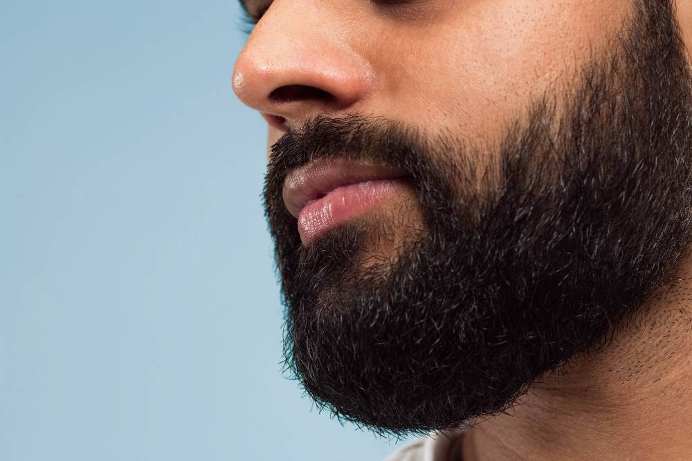 close-up-portrait-young-hindoo-man-s-face-with-beard-lips-blue-space (1)
